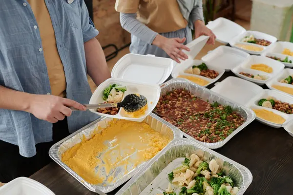 Volunteers preparing food packs for distribution
