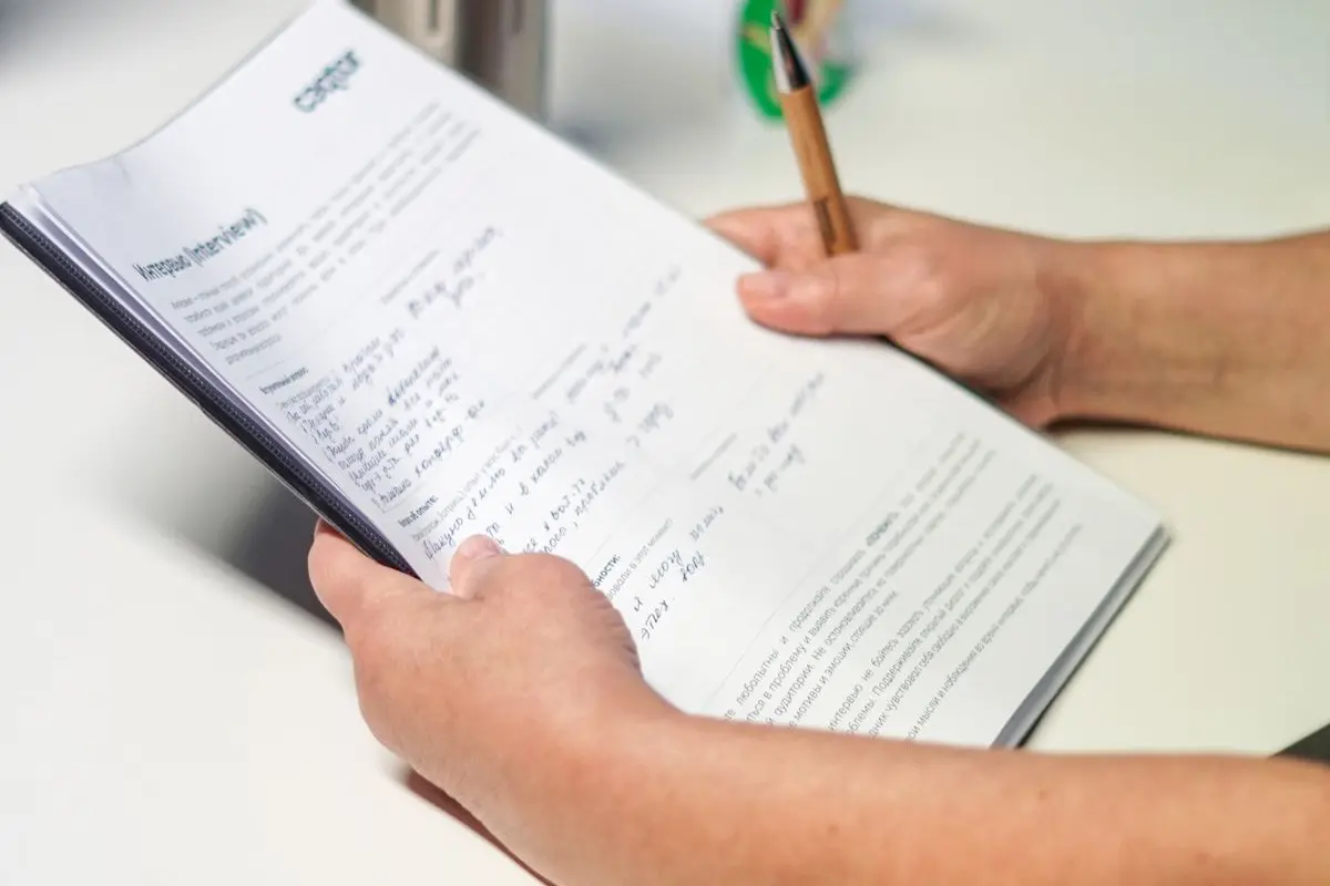 A person checking documents at an office desk