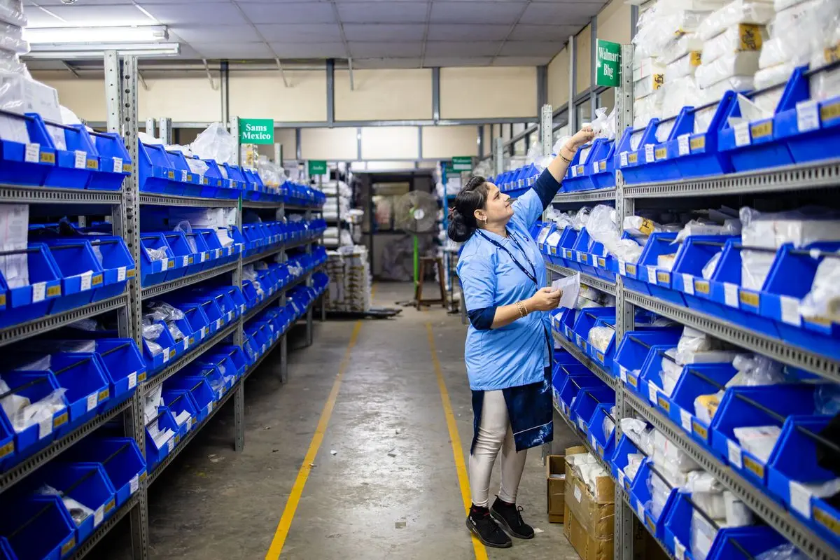 A warehouse worker organising stock on shelves