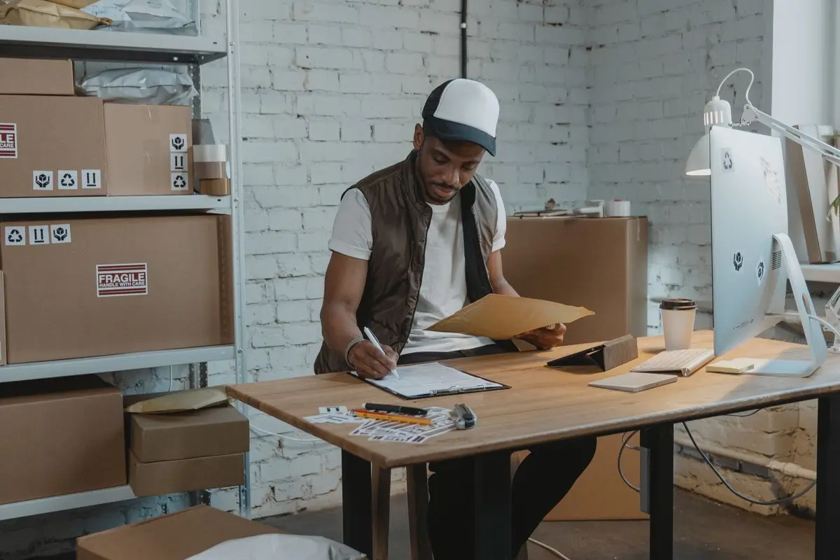 A colleague writing information on a document