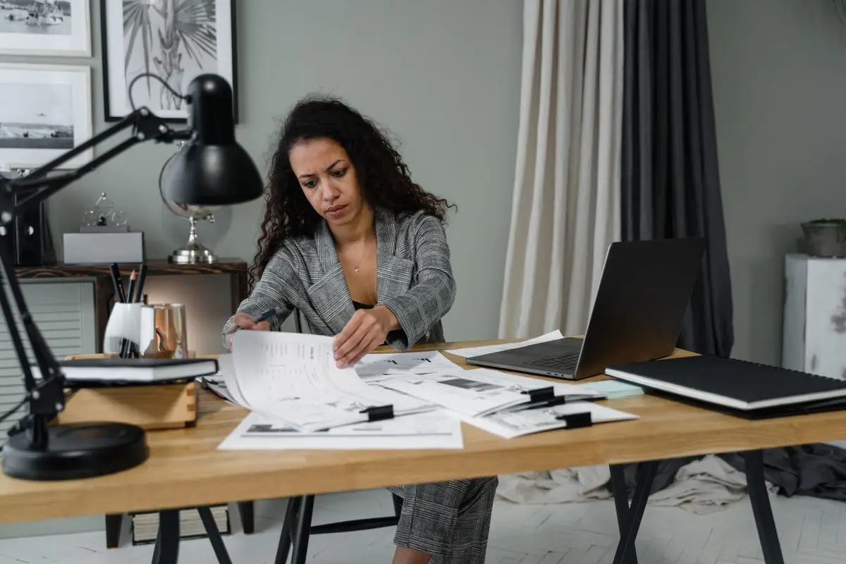 An office colleague reviewing papers at a desk