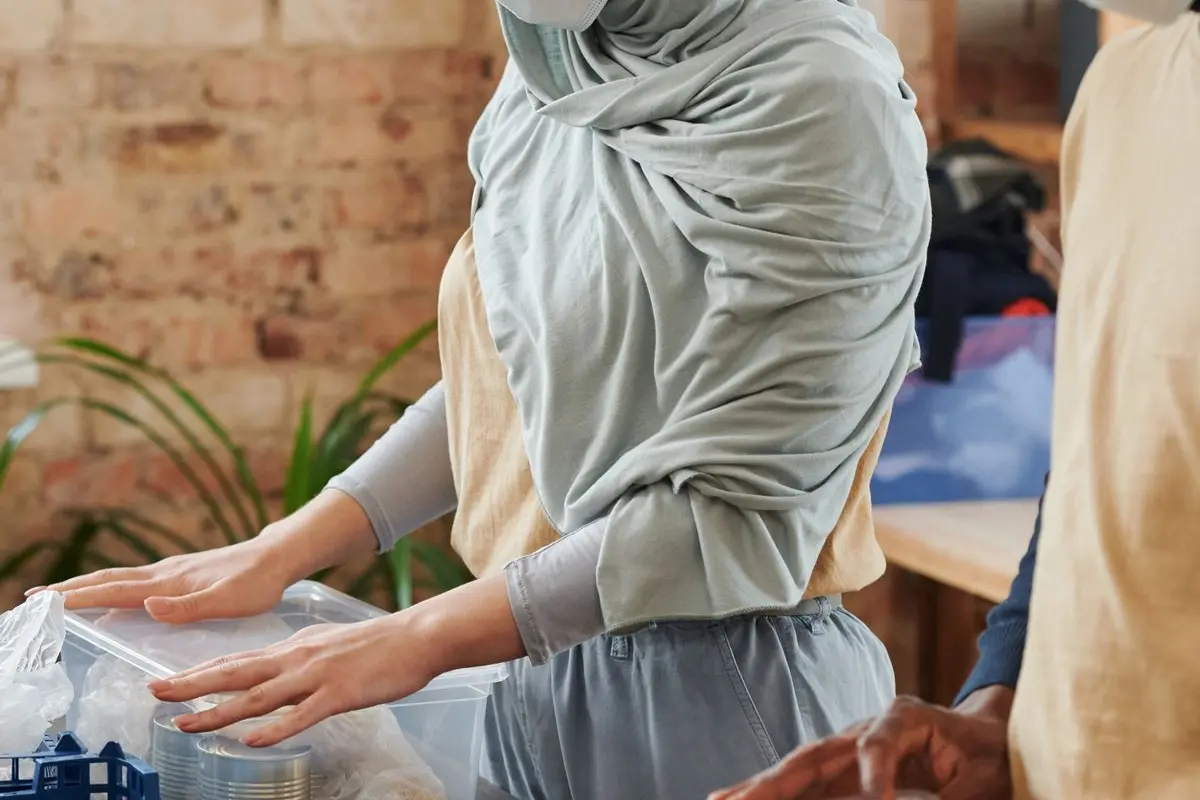 Volunteers packing donations while wearing face coverings