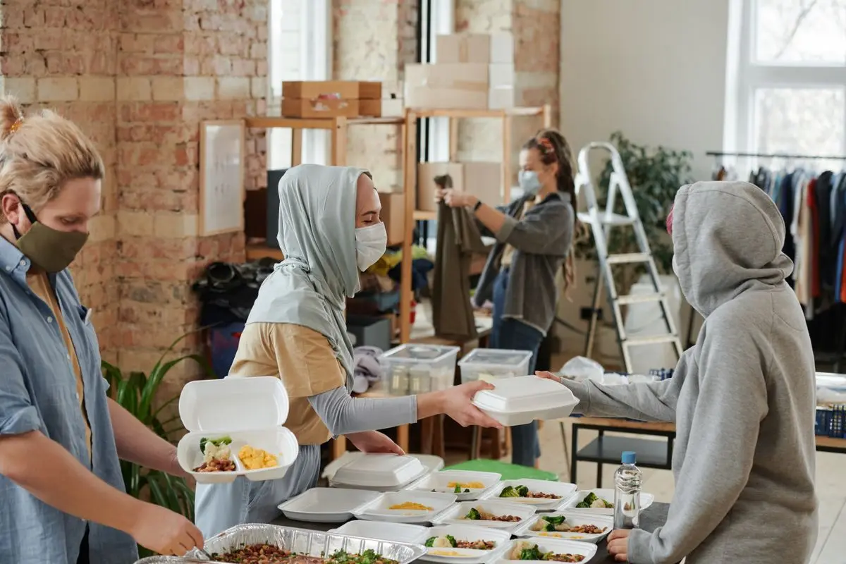 Volunteers distributing prepared food
