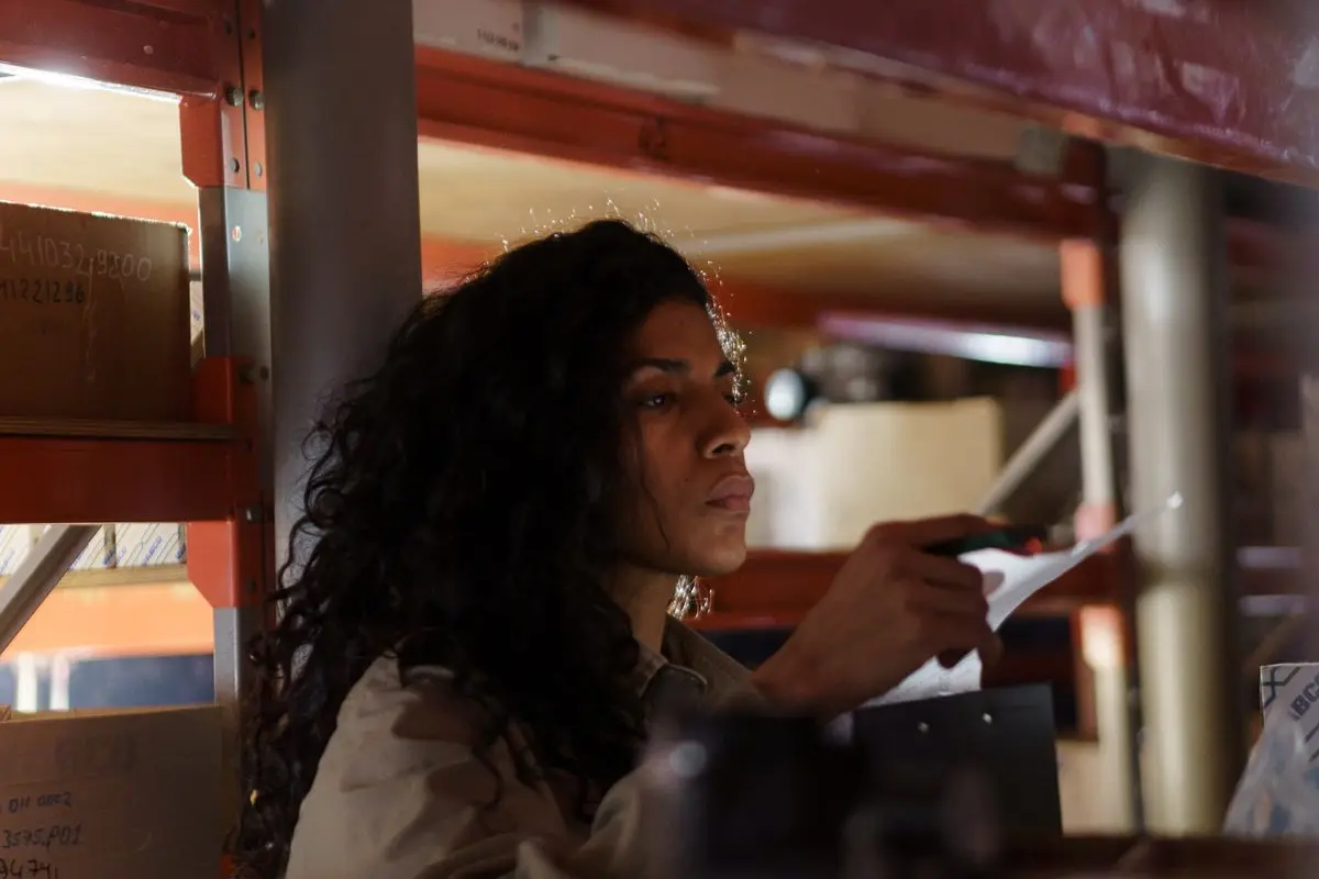 A warehouse worker checking a document