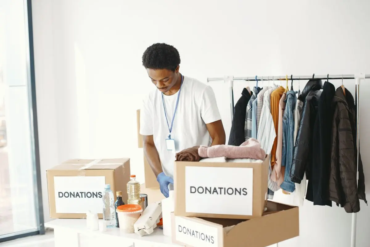 A volunteer packing a box of supplies