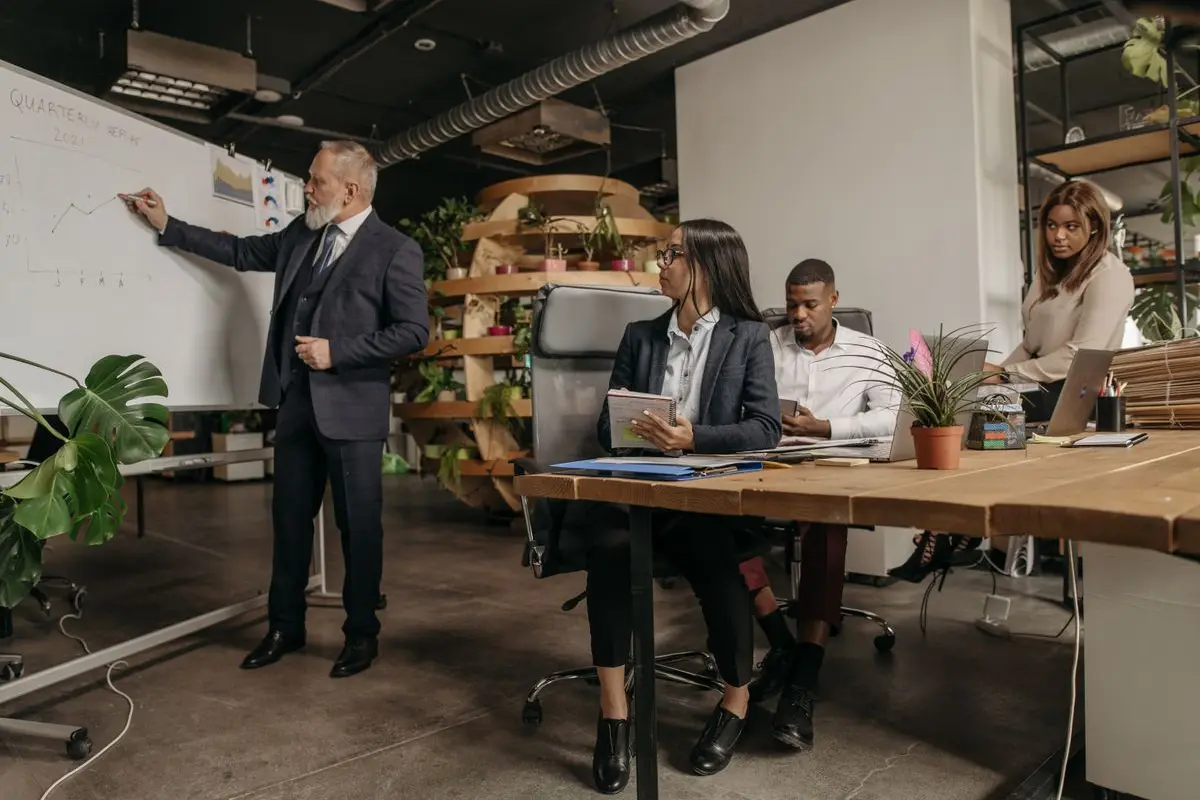 Colleagues discussing work around an office table