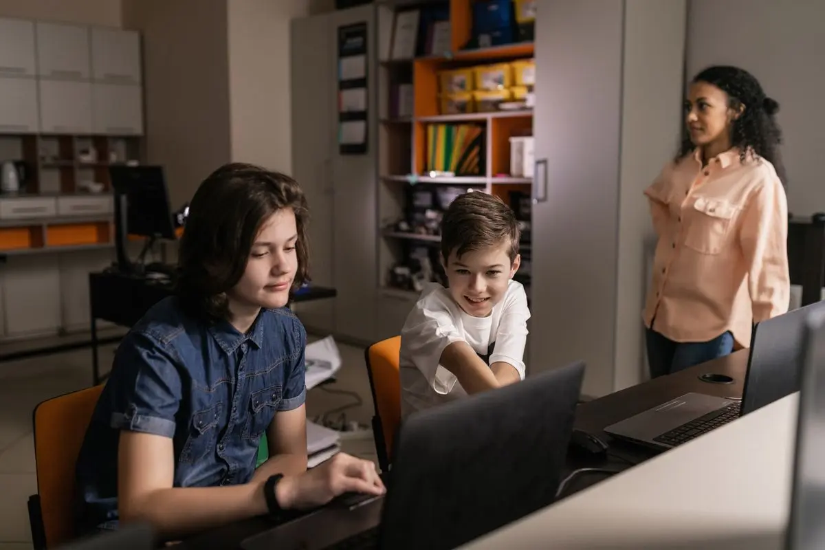 Pupils using laptops in a classroom
