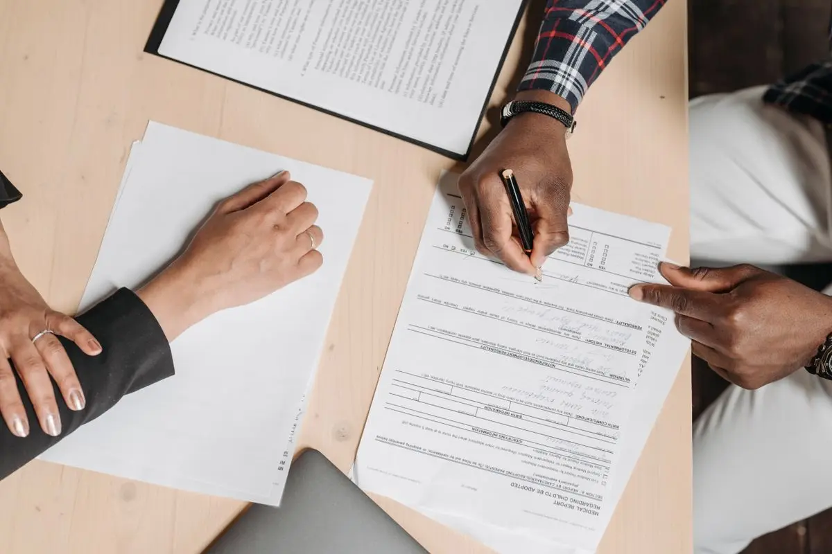 Colleagues reviewing paperwork together at a table