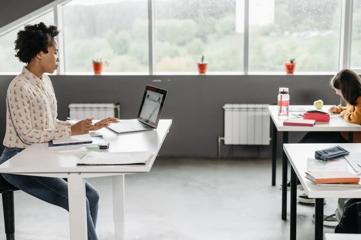 A teacher working at a classroom desk